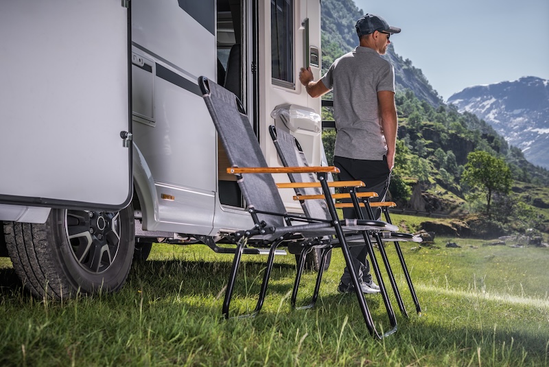 Vacation in a Recreational Vehicle. Caucasian RV Owner in Front of His Vehicle.