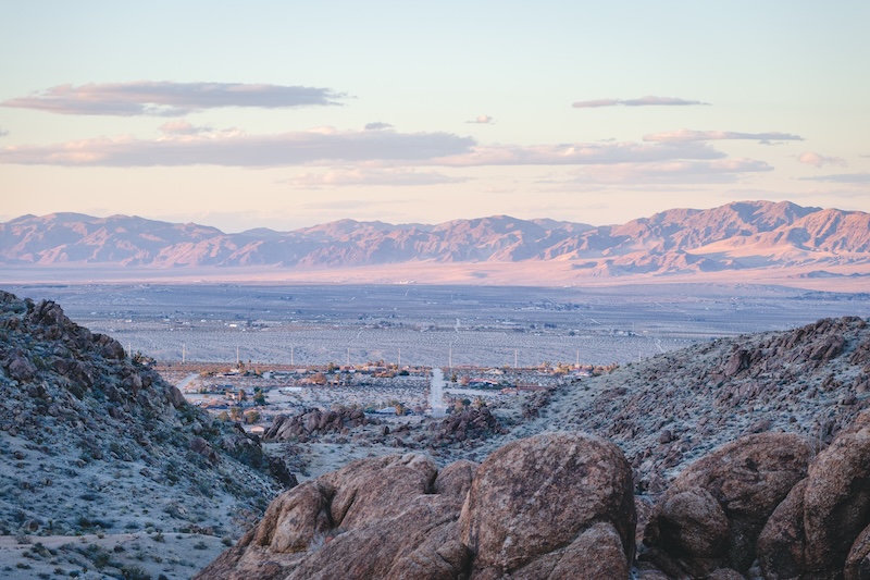 View over the desert at sunset, towards distant mountain ranges, Joshua Tree National Park and Twentynine Palms.