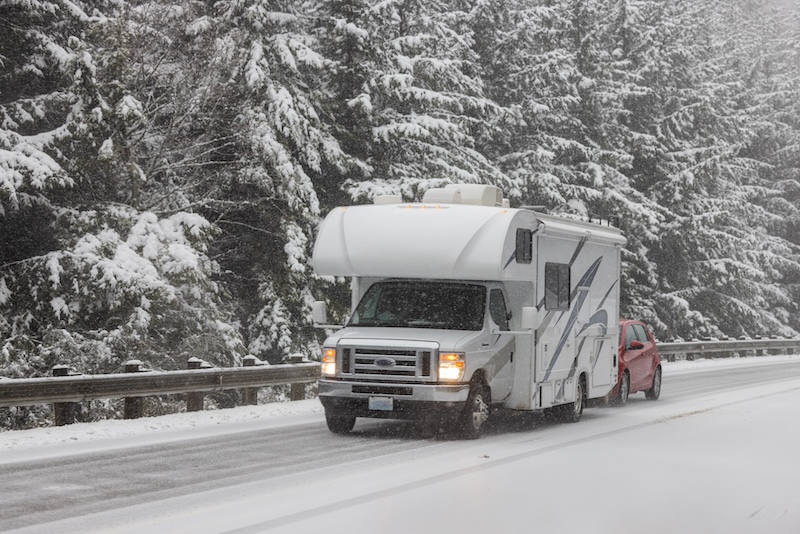 RV driving on fresh snow after a rare winter storm brought snow to the Oregon Coast, February 2023.