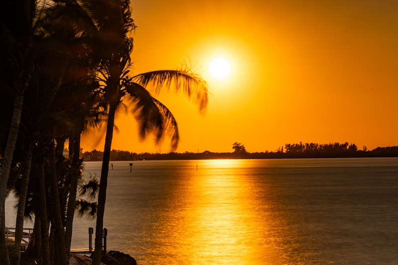 Orange sunset at Siesta Key beach with sunshine, Sarasota, Florida